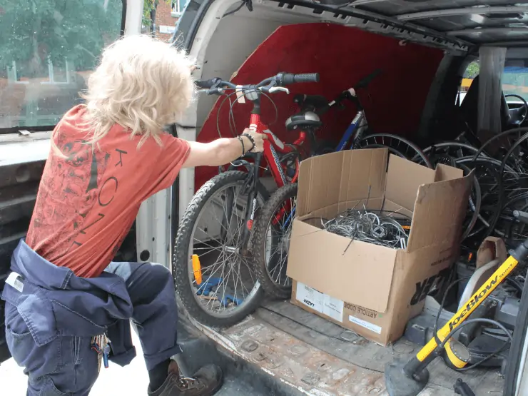 Recyborg worker unloading a bike from van
